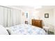 Cozy bedroom featuring a comfortable bed with blue floral pattern bedding and a classic wooden dresser at 7970 S Cook Way, Centennial, CO 80122