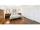 A bedroom featuring hardwood floors, a queen bed, matching nightstands, and decor at 7970 S Cook Way, Centennial, CO 80122