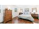 Bedroom featuring hardwood floors, light colored walls, and lots of furniture at 7970 S Cook Way, Centennial, CO 80122