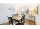 Dining room with a wooden table, six chairs, and natural light from a shuttered window at 7970 S Cook Way, Centennial, CO 80122