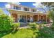 Charming home exterior with well-manicured lawn and inviting front porch and seating at 7970 S Cook Way, Centennial, CO 80122