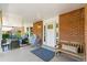Inviting covered front porch featuring brick accents and comfortable seating at 7970 S Cook Way, Centennial, CO 80122