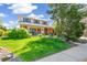 Charming two-story home with inviting front porch and beautiful lawn at 7970 S Cook Way, Centennial, CO 80122
