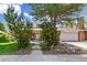 Well-maintained home featuring a front yard with mature trees and attached garage at 7970 S Cook Way, Centennial, CO 80122