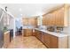 Sunny kitchen featuring wood cabinets, solid surface counters, stainless steel appliances, and wood flooring at 7970 S Cook Way, Centennial, CO 80122