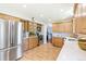 Bright kitchen with stainless steel appliances, light wood cabinets, and solid surface counters at 7970 S Cook Way, Centennial, CO 80122