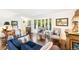 Bright living room featuring a bay window, hardwood floors, and comfortable furniture at 7970 S Cook Way, Centennial, CO 80122