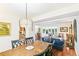 Open living and dining areas with hardwood floors, wood furniture, and bright natural light at 7970 S Cook Way, Centennial, CO 80122