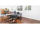 Office area with wood floors, two windows, and a printer on the desk at 7970 S Cook Way, Centennial, CO 80122