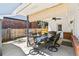 Covered patio with outdoor dining set, grill, fan, and brick accents at 7970 S Cook Way, Centennial, CO 80122