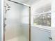 Bathroom shower with glass doors and updated shower head with window at 7970 S Cook Way, Centennial, CO 80122