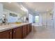Bathroom with a double sink vanity, soaking tub, and glass-enclosed shower at 860 Bramblewood Dr, Castle Pines, CO 80108