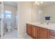 Bathroom featuring tile floors, vanity with sink, and a toilet and shower behind a partial wall at 860 Bramblewood Dr, Castle Pines, CO 80108