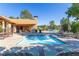 Community pool featuring comfortable lounge chairs and a covered seating area for relaxation at 860 Bramblewood Dr, Castle Pines, CO 80108