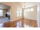 Spacious dining room with hardwood floors, vaulted ceilings, and a modern chandelier at 860 Bramblewood Dr, Castle Pines, CO 80108