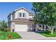 Charming two-story home with stone accents, a well-maintained lawn, and a two car garage at 860 Bramblewood Dr, Castle Pines, CO 80108