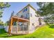 Beautiful exterior of a house with a wooden deck and a white-fenced patio area at 860 Bramblewood Dr, Castle Pines, CO 80108