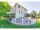 Exterior of a two-story house showing a well-kept yard and a cozy outdoor patio with seating at 860 Bramblewood Dr, Castle Pines, CO 80108