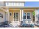 Inviting front porch with comfortable seating and decorative accents for relaxing outdoor enjoyment at 860 Bramblewood Dr, Castle Pines, CO 80108