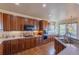 Spacious kitchen featuring wooden cabinets, stainless steel appliances, and ample countertop space at 860 Bramblewood Dr, Castle Pines, CO 80108