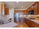 Modern kitchen features stainless steel appliances, wooden cabinets, and hardwood flooring at 860 Bramblewood Dr, Castle Pines, CO 80108