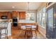 Cozy kitchen with wooden cabinets, stainless appliances, and a charming dining area at 860 Bramblewood Dr, Castle Pines, CO 80108