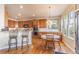 Charming kitchen with wood cabinetry, stainless steel appliances, and an eat-in dining area at 860 Bramblewood Dr, Castle Pines, CO 80108