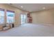 Open living room with neutral carpet, sliding doors, and natural light at 860 Bramblewood Dr, Castle Pines, CO 80108