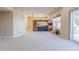 Spacious living room with neutral carpet, custom built-ins, and sliding door access to the outdoor deck at 860 Bramblewood Dr, Castle Pines, CO 80108