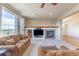 Open-concept living room featuring a fireplace, built-in media center, and comfortable seating at 860 Bramblewood Dr, Castle Pines, CO 80108