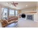Comfortable living room with a fireplace, media center, plush seating, and large view windows at 860 Bramblewood Dr, Castle Pines, CO 80108