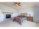 Bright main bedroom with a fireplace, neutral decor, and comfortable furnishings at 860 Bramblewood Dr, Castle Pines, CO 80108