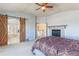 Spacious main bedroom with a fireplace, barn door to bathroom, and neutral decor at 860 Bramblewood Dr, Castle Pines, CO 80108