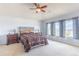 Serene main bedroom featuring large windows, ceiling fan, and neutral décor at 860 Bramblewood Dr, Castle Pines, CO 80108