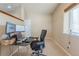 Bright office featuring carpet, large windows, and views to the back patio at 860 Bramblewood Dr, Castle Pines, CO 80108