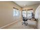 Bright office featuring carpet, large windows, and views to the back patio at 860 Bramblewood Dr, Castle Pines, CO 80108