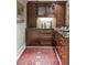 Bar area featuring wood cabinets, decorative backsplash, granite countertop, and a patterned area rug at 395 N Franklin St, Denver, CO 80218