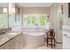 Bathroom featuring a soaking tub, separate shower, and marble countertops at 395 N Franklin St, Denver, CO 80218