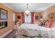 Bedroom with a fireplace, white bed frame, patterned curtains, and a hanging pendant light at 395 N Franklin St, Denver, CO 80218
