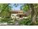 Beautiful home exterior with manicured lawn and flowering trees under a bright sky at 395 N Franklin St, Denver, CO 80218