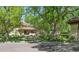 Charming home exterior with lush landscaping, mature trees, and a red-tiled roof at 395 N Franklin St, Denver, CO 80218