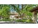 Charming home exterior with lush landscaping, mature trees, and a red-tiled roof at 395 N Franklin St, Denver, CO 80218