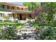 Inviting home facade featuring stone steps, lush garden beds, and a charming covered entrance at 395 N Franklin St, Denver, CO 80218