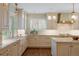 Well-lit kitchen featuring farmhouse sink, shaker cabinets, marble countertops, and stainless steel appliances at 395 N Franklin St, Denver, CO 80218