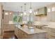 Bright kitchen with large island, marble countertops, custom cabinets, and unique light fixtures at 395 N Franklin St, Denver, CO 80218