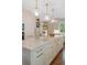 Kitchen island with marble countertop, sink, and stainless steel appliances in a luxurious setting at 395 N Franklin St, Denver, CO 80218