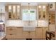Bright kitchen with farmhouse sink, custom cabinetry, and a window with a view at 395 N Franklin St, Denver, CO 80218