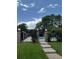 Community pool behind a decorative wrought iron fence, under a sunny sky with mature trees at 1755 S Pitkin St # B, Aurora, CO 80017