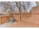 Backyard deck has privacy fence, access gate, brick pavers, and an included air conditioning unit at 11973 E Kepner Dr, Aurora, CO 80012