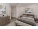 Staged bedroom featuring a bed, stylish dresser, and natural light from the window at 11973 E Kepner Dr, Aurora, CO 80012